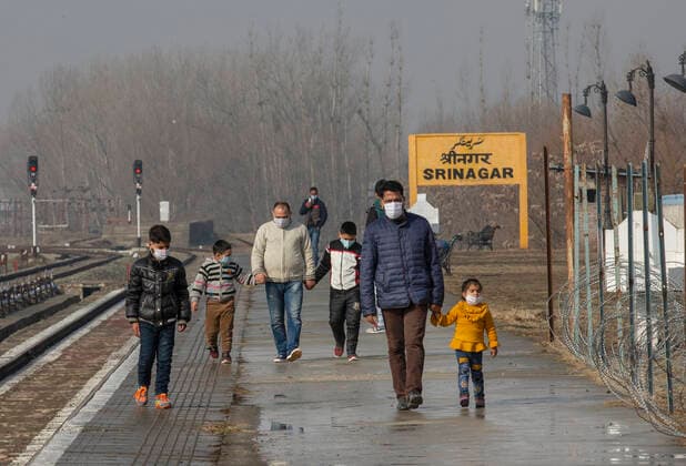(210223) -- SRINAGAR, Feb. 23, 2021 -- Passengers wearing face masks walk on a railway platform in Srinagar city, the summer capital of Indian-controlled Kashmir, Feb. 23, 2021. Train service was resumed partially in Indian-controlled Kashmir after a gap of 11 months, officials said Tuesday. The service was suspended on March 19 last year owing to the outbreak of the COVID-19 pandemic. ) KASHMIR-TRAIN SERVICE-RESUMPTION JavedxDar 