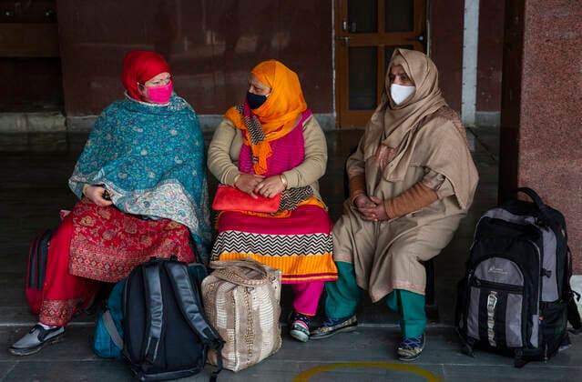 (210223) -- SRINAGAR, Feb. 23, 2021 -- Passengers wearing face masks wait for a train at a train station in Srinagar city, the summer capital of Indian-controlled Kashmir, Feb. 23, 2021. Train service was resumed partially in Indian-controlled Kashmir after a gap of 11 months, officials said Tuesday. The service was suspended on March 19 last year owing to the outbreak of the COVID-19 pandemic. ) KASHMIR-TRAIN SERVICE-RESUMPTION JavedxDar 