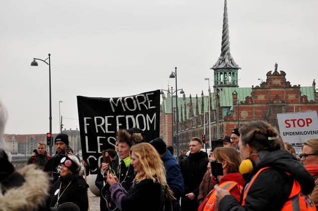 Copenhagen, Denmark. 23 February 2021, Danes proetesting againest coronavirus pandemic new debate in danish parliamenet about quick corona virus pandemic law in danish parliament with all political parties and stage anti pandemic law debates in front of danish parliament and danish police stand peaceful proteact danish parliament in front christiansborg danish parliament in Copenhagen. (Photo..Francis Dean Deanpictures)