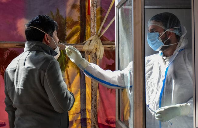 February 23, 2021, Srinagar, India: A health worker takes a nasal swab of a man for a Covid-19 test at a coronavirus testing center in Srinagar..Jammu and Kashmir recorded 58 new COVID-19 cases which took the infection tally to 125,925, officials said. A senior doctor has warned of a second wave of COVID 19 infections, the warning has come at a time when Kashmir valley is witnessing a sharp decrease in daily cases. Srinagar India - ZUMAs197 20210223_zaa_s197_018 Copyright: xSaqibxMajeedx