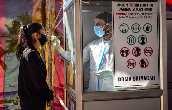 February 23, 2021, Srinagar, India: A health worker takes a nasal swab of a girl for a Covid-19 test at a coronavirus testing center in Srinagar..Jammu and Kashmir recorded 58 new COVID-19 cases which took the infection tally to 125,925, officials said. A senior doctor has warned of a second wave of COVID 19 infections, the warning has come at a time when Kashmir valley is witnessing a sharp decrease in daily cases. Srinagar India - ZUMAs197 20210223_zaa_s197_024 Copyright: xSaqibxMajeedx