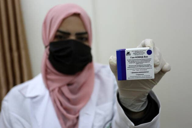 February 23, 2021, Khan Yunis, Gaza Strip, Palestinian Territory: A Palestinian health worker displays a box of the Russian Sputnik V coronavirus vaccine at European Hospital, in Khan Yunis, in the southern Gaza Strip on February 23, 2021. Around 20,000 coronavirus vaccine doses from the UAE arrived in Gaza, a delivery reportedly orchestrated by a rival of Palestinian president Mahmud Abbas three months before scheduled Palestinian elections Khan Yunis Palestinian Territory - ZUMAap3_ 20210223_zaf_ap3_052 Copyright: xAshrafxAmrax