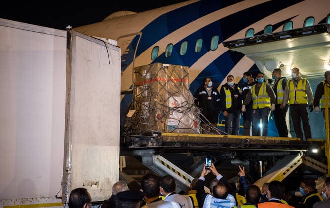(210223) -- CAIRO, Feb. 23, 2021 -- Workers upload a batch of China s Sinopharm COVID-19 vaccines onto a truck in Cairo International Airport, Egypt, Feb. 23, 2021. The shipment of COVID-19 vaccines from Chinese company Sinopharm arrived in Egyptian capital Cairo on Tuesday. ) EGYPT-CAIRO-CHINA-VACCINE-ARRIVAL WuxHuiwo 