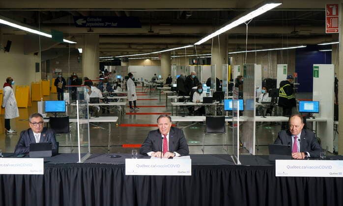 February 23, 2021, Montreal, PQ, Canada: Quebec Premier Francois Legault, Health Minister Christian Dube, right, and Dr. Horacio Arruda, Quebec s director of public health, hold a new conference in a COVID-19 vaccination clinic in Montreal s Olympic Stadium on Tuesday, February 23, 2021. Montreal Canada - ZUMAc35_ 20210223_zaf_c35_041 Copyright: xPaulxChiassonx