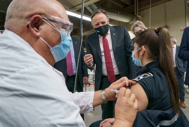 February 23, 2021, Montreal, PQ, Canada: Quebec Premier Francois Legault watches a woman get her COVID-19 vaccine at a clinic in Montreal s Olympic Stadium on Tuesday, February 23, 2021. Montreal Canada  - ZUMAc35_ 20210223_zaf_c35_046 Copyright: xPaulxChiassonx