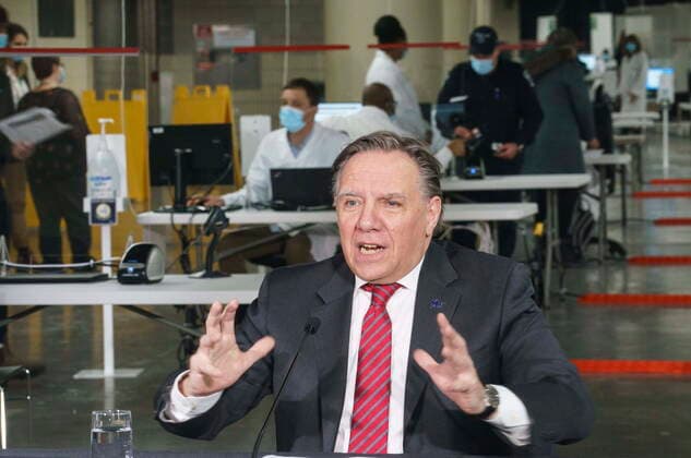 February 23, 2021, Montreal, PQ, Canada: Quebec Premier Francois Legault responds to a question during a new conference in a COVID-19 vaccination clinic at Montreal s Olympic Stadium on Tuesday, February 23, 2021. Montreal Canada  - ZUMAc35_ 20210223_zaf_c35_053 Copyright: xPaulxChiassonx