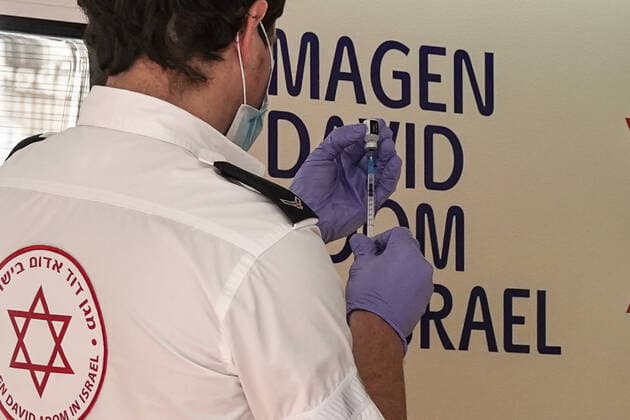 February 24, 2021, Jerusalem, Israel: The IDF Home Front Command in coordination with Magen David Adom, serving as the Israeli Red Cross organization and leading EMS, make COVID-19 vaccinating more accessible to those still in denial or refusal operating a mobile vaccination station out of a caravan at JerusalemÃ¢â‚¬â ¢s Shuk Mahane Yehuda Market. Jerusalem Israel - ZUMAa126 20210224_zap_a126_014 Copyright: xNirxAlonx