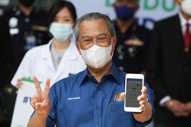 February 20, 2021, Putrajaya, Malaysia: Prime Minister, Muhyiddin Yassin poses for a photo after receiving the first dose of Pfizer-BioNTech COVID-19 Vaccine in Putrajaya. .Malaysia will launch the largest immunization program ever to be carried out in the country. 532 Vaccination Centers nationwide are set to begin the National COVID-19 Immunization Program starting February 24, 2021. The first phase will involve 500,000 medical staff and non-medical staff. Putrajaya Malaysia - ZUMAs197 20210220_zaa_s197_458 Copyright: xCalvinxPanx