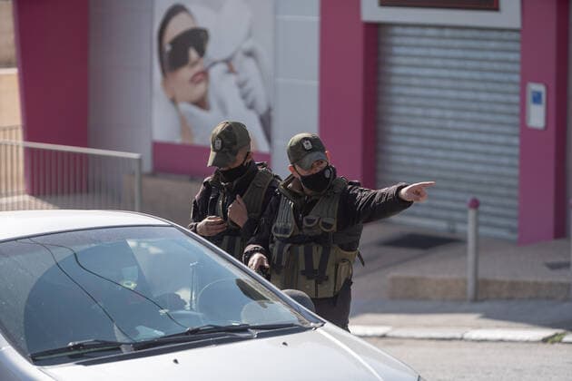 (210224) -- BETHLEHEM, Feb. 24, 2021 -- Palestinian police officers work at a checkpoint on one of the main roads in Beit Sahour near the West Bank city of Bethlehem, Feb. 24, 2021. The Governor of Bethlehem announced the closure of Beit Sahour for 48-hours starting from 12:00 am Wednesday, after increase of the numbers of COVID-19 infections. (Photo by Xinhua) MIDEAST-BETHLEHEM-COVID-19-CHECKPOINT LuayxSababa 