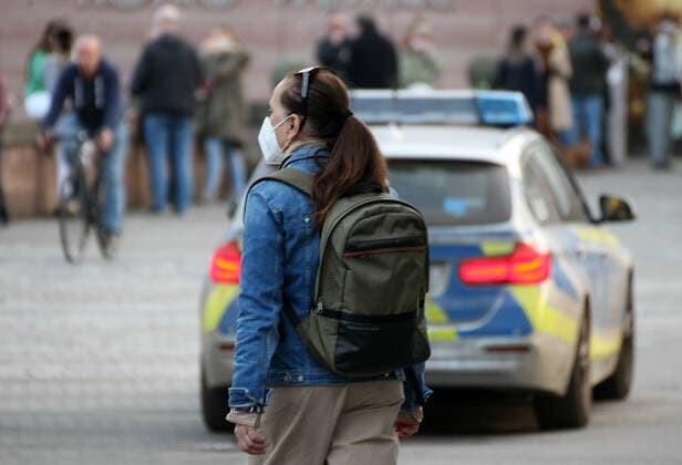 a girl with Safety Mask is seen as the Police make a Kontrolle during the Hard Lockdown of the Covid 19 Coronavirus Pandemie in Nurnberg , Bayern , Deutschland . February 24, 2021.