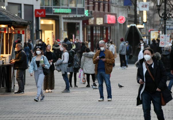 People walk in the street with Safety Mask during the Hard Lockdown of the Covid 19 Coronavirus Pandemie in Nurnberg , Bayern , Deutschland . February 24, 2021.