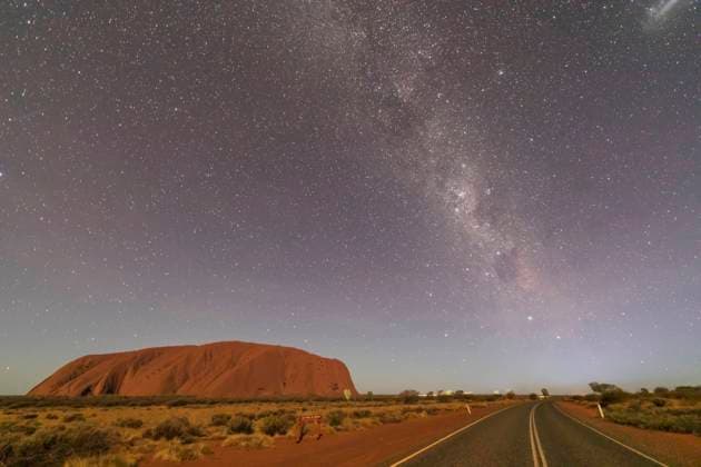 Australia, Northern Territory, Milky Way galaxy over Uluru (Ayers Rock) and empty highway at dusk property released FOF12052