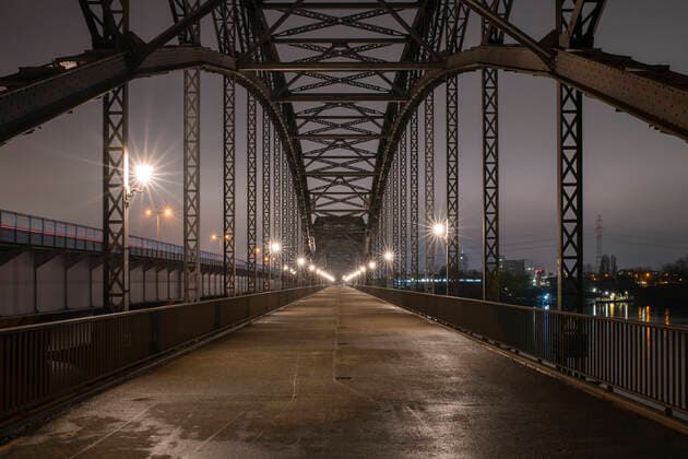 Germany, Hamburg, Diminishing perspective of Alte Harburger Elbbrucke bridge at night RJF00856