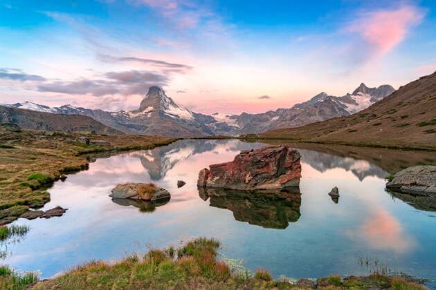Pink sky at dawn over Matterhorn reflected in lake Stellisee, Zermatt, Valais Canton, Switzerland, Europe Copyright: RobertoxMoiola 1179-4873