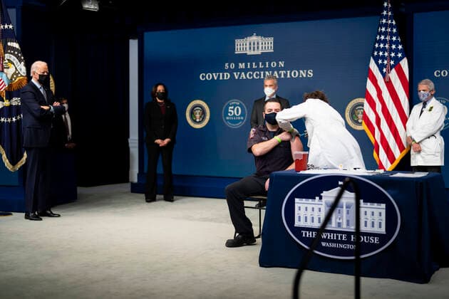 February 25, 2021, Washington, District of Columbia, USA: President Joe Biden looks on as a nurse gives a vaccine to Corey Hamilton, a firefighter EMT stationed at Engine Company 9 in Northwest DC, as he participates in an event commemorating the 50 million COVID-19 vaccine shot during a ceremony at the White House, Thursday, Feb. 25, 2021 Washington USA - ZUMAs152 20210225_zaa_s152_193 Copyright: xDougxMillsx