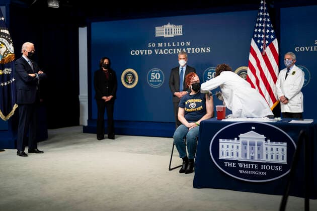 February 25, 2021, Washington, District of Columbia, USA: President Joe Biden looks on as a nurse gives a vaccine to Victoria Legerwood Rivera, an Attendance Counselor at Stoddert Elementary School in Northwest DC, as he participates in an event commemorating the 50 million COVID-19 vaccine shot during a ceremony at the White House, Thursday, Feb. 25, 2021 Washington USA - ZUMAs152 20210225_zaa_s152_201 Copyright: xDougxMillsx