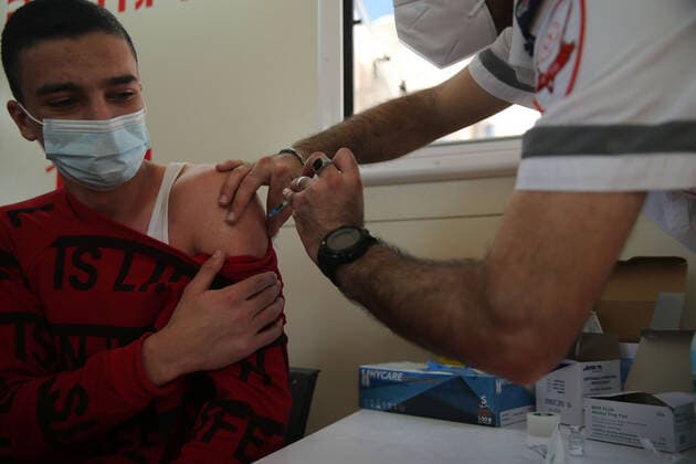 (210226) -- JERUSALEM, Feb. 26, 2021 -- A man receives the COVID-19 vaccine in a mobile clinic in Jerusalem, on Feb. 26, 2021. (Photo by Xinhua) MIDEAST-JERUSALEM-COVID-19-VACCINATION MuammarxAwad 