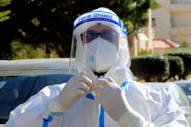 (210227) -- AMMAN, Feb. 27, 2021 -- A health worker prepares to collect samples for COVID-19 tests in Amman, Jordan, Feb. 26, 2021. Jordan on Wednesday decided to reinstate curfew on each Friday starting from Feb. 26 in addition to extending daily curfew by two hours as part of anti-pandemic measures as infections keep rising in the kingdom. During a press conference on Wednesday, Minister of State for Media Affairs Ali Al Ayed announced that businesses are allowed to operate until 9 p.m. local time while public movement will be permitted from 6 a.m. until 10 p.m. as of Thursday. (Photo by Xinhua) JORDAN-AMMAN-COVID-19-CURFEW MohammadxAbuxGhosh 