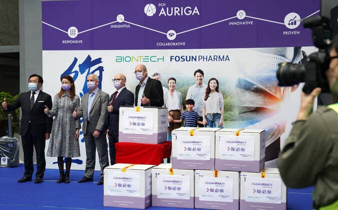 (210227) -- HONG KONG, Feb. 27, 2021 -- Guests celebrate the arrival of the Comirnaty COVID-19 vaccine at a logistics center in Hong Kong, south China, Feb. 27, 2021. A total of 585,000 doses of the Comirnaty COVID-19 vaccine procured by the Hong Kong Special Administrative Region (HKSAR) government arrived in Hong Kong from Germany on Saturday. These were among the first batch of 1 million doses of the Comirnaty vaccine, developed by Fosun Pharma and BioNTech, delivered to Hong Kong. The remaining doses will arrive in early March, a spokesman for the HKSAR government said. The online booking system for this vaccine will open next week. ) CHINA-HONG KONG-COVID-19 VACCINE(CN) LixGang 