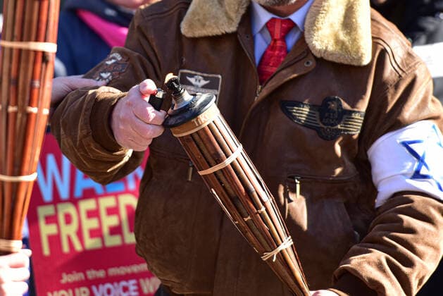 February 27, 2021, Calgary, Alberta, Canada: Preacher Artur Pawlowski lights a tiki torch at the the anti-mask protest Freedom March in Calgary, AB on 27 Feb, 2021. . The march was led by people carrying tiki torches said to signify the light of the lord but also reminiscent of the Charlottesville Unite the Right rally in 2017. Calgary Canada - ZUMAj113 20210227_zip_j113_003 Copyright: xGavinxJohnx
