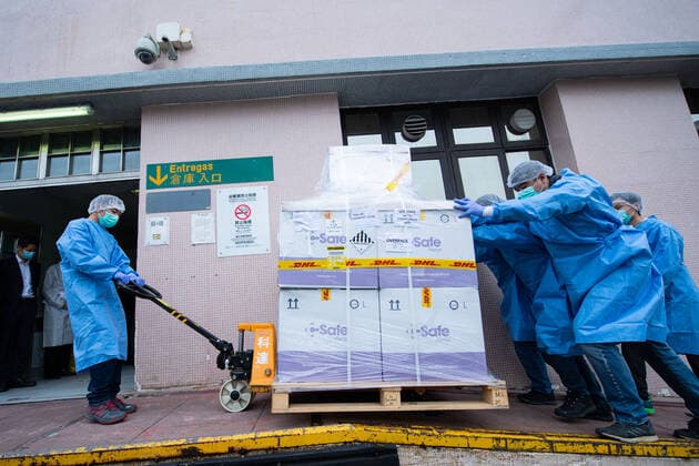 (210228) -- MACAO, Feb. 28, 2021 -- Staff members transfer vaccines in Macao, south China, Feb. 27, 2021. The first batch of 100,000 doses of mRNA vaccines made in Germany arrived in Macao on Saturday. ) CHINA-MACAO-VACCINES-ARRIVAL (CN) CheongxKamxKa 