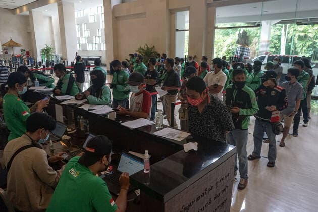 February 28, 2021, Badung, Bali, Indonesia: Hundreds of online taxi drivers and touirsm workers lined up to get their vaccination turn. Bali to held the second stage of Covid-19 mass vaccination towards tourism workers and online-taxi drivers at Bali Nusa Dua Convention Center (BNDCC), in order to accelerate tourism industry recovery. About 5000 doses of vaccines are targeted to be completed within 1 week. Badung Indonesia - ZUMAb245 20210228_zip_b245_005 Copyright: xDickyxBisinglasix