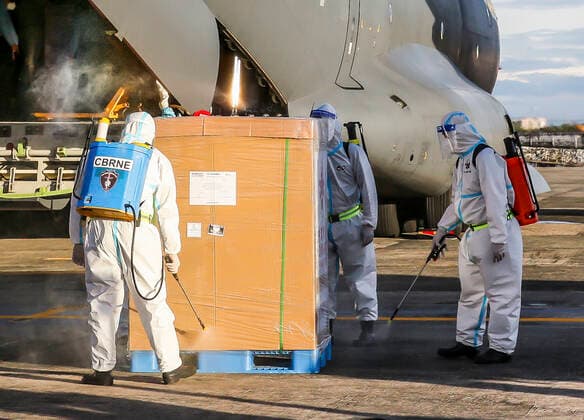 (210228) -- MANILA, Feb. 28, 2021 -- Vaccines donated by China arrives at a Philippine Air Force base in Manila, the Philippines, on Feb. 28, 2021. A batch of Sinovac vaccine CoronaVac donated by China arrived in the Philippines on Sunday, the first COVID-19 vaccine to reach the Southeast Asian country. The delivery of the vaccines allows the Philippines to start mass vaccinations soon, marking a new phase in the country s fight against the COVID-19 that infected 576,352 and killed 12,318. ) PHILIPPINES-MANILA-COVID-19-VACCINE-ARRIVAL ROUELLExUMALI 
