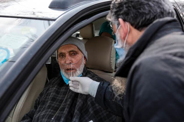 (210228) -- SRINAGAR, Feb. 28, 2021 -- A health worker takes a nasal swab sample from a man to test with Rapid Antigen Test (RAT) for the COVID-19 in Srinagar city, the summer capital of Indian-controlled Kashmir, Feb. 28, 2021. ) KASHMIR-SRINAGAR-COVID-19 JavedxDar 