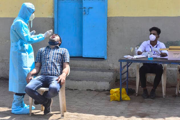 MUMBAI, INDIA - FEBRUARY 27: BMC medical staff conducts swab test of resident staying at Dharavi, on February 28, 2021 in Mumbai, India. (Photo by Anshuman Poyrekar Hindustan Times) Medical Team Conducts COVID-19 Coronavirus Test