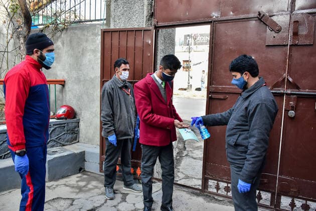 March 1, 2021, Srinagar, India: A student gets sanitized at the gate before entering school as the schools reopened after one year of break due to the coronavirus pandemic in Srinagar..The schools in Kashmir have reopened for students of classes 9 to 12 after being shut down for nearly one year due to the coronavirus pandemic. Even before the Covid-19 forced their closure, the educational institutes remained closed for nearly a year on of the security and communication clampdown following the abrogation of Article 370 on 5 August 2019. Meanwhile, Jammu and Kashmir recorded 97 new Covid-19 cases taking the infection tally to 1,26,383, officials said. Srinagar India - ZUMAs197 20210301_zaa_s197_050 Copyright: xSaqibxMajeedx