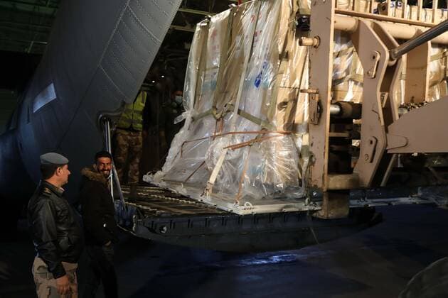 (210302) -- BAGHDAD, March 2, 2021 -- Staff members unload the COVID-19 vaccines donated by China at an airbase in Baghdad, Iraq, March 2, 2021. Iraq received a shipment of China s COVID-19 vaccines on Tuesday. ) IRAQ-BAGHDAD-COVID-19-CHINA-VACCINES-ARRIVAL KhalilxDawood 