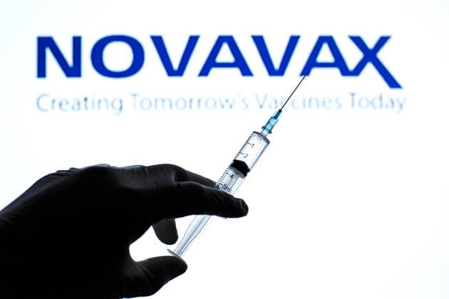 March 2, 2021, Barcelona, Catalonia, Spain: In this photo illustration a close up of a hand holding a medical syringe in front of the Novavax logo. Barcelona Spain - ZUMAd159 20210302_zia_d159_002 Copyright: xThiagoxPrudenciox