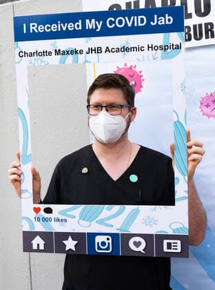 (210303) -- JOHANNESBURG, March 3, 2021 -- A health worker poses for a photo after receiving COVID-19 vaccine in Charlottle Maxeke Academic Hospital in Johannesburg, South Africa, March 2, 2021. As COVID-19 cases decline, South African cabinet eased lockdown restrictions from alert level three to level one, allowing political and religious gatherings, President Cyril Ramaphosa said on Sunday night. (Photo by Xinhua) SOUTH AFRICA-JOHANNESBURG-COVID-19-VACCINATION MatthewxMartinxBrink 