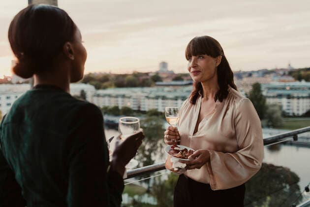 Smiling female colleagues with champagne in office during party Sweden, Stockholm, model released, property released Copyright: xMaskotx , MA84635