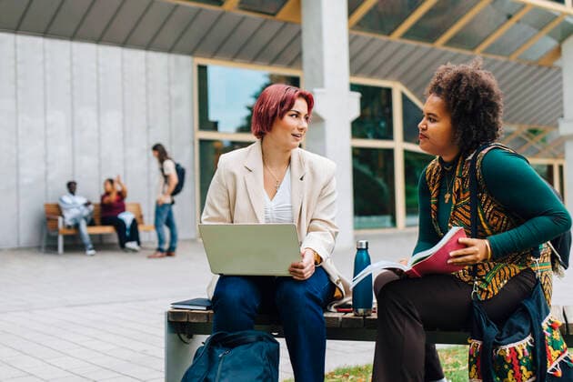 Female students talking with each other while studying in university campus Sweden, Stockholm, model released Copyright: xMaskotx , MA84723