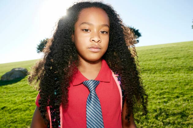 Young mixed race girl in pink shirt and formal tie, wearing a backpack United States,Young mixed race girl in pink shirt and formal tie, wearing a backpack  Young mixed race girl in pink shirt and formal tie, wearing a backpack