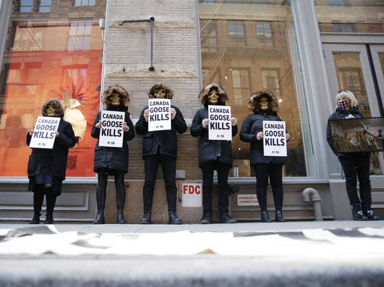 PETA protesters wearing skull masks and fake Canada Goose coats holds signs at a protest outside of a Canada Goose retail store in New York City on Wednesday, March 3, 2021. The protest is part of a week of action that will also include Canada Goose protests in Beverly Hills, California, Boston and Pittsburgh.  NYP20210303106 JohnxAngelillo