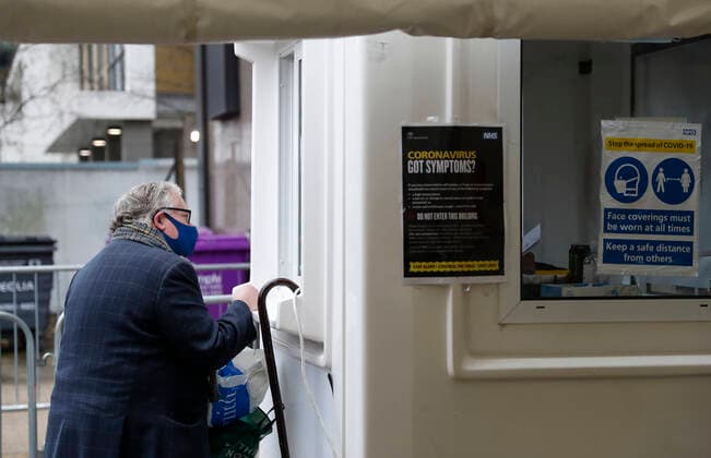 (210305) -- LONDON, March 5, 2021 -- A man is seen at an NHS COVID-19 vaccination center in London, Britain, on March 4, 2021. Future vaccines that have been tweaked to deal with new coronavirus variants will be fast-tracked for authorization, Britain s medicines and health care regulator announced Thursday. ) BRITAIN-LONDON-COVID-19-VACCINE HanxYan 