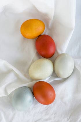 Naturally dyed orange, yellow, and blue Easter Eggs in a layflat Bridgeport, CT, United States CR_CATO210305B-670820-01