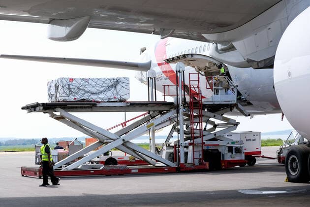 (210306) -- ENTEBBE, March 6, 2021 -- Photo taken on March 5, 2021 shows AstraZeneca-Oxford vaccines from COVAX vaccine sharing program being unloaded from a plane at Entebbe International Airport, Uganda. Uganda on Friday received the first batch of COVID-19 vaccines from COVAX facility. (Photo by Xinhua) UGANDA-ENTEBBE-COVAX-COVID-19 VACCINES-ARRIVAL HajarahxNalwadda 