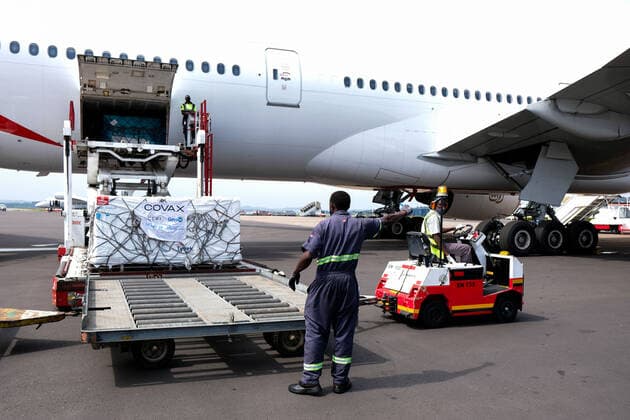 (210306) -- ENTEBBE, March 6, 2021 -- Photo taken on March 5, 2021 shows AstraZeneca-Oxford vaccines from COVAX vaccine sharing program being unloaded from a plane at Entebbe International Airport, Uganda. Uganda on Friday received the first batch of COVID-19 vaccines from COVAX facility. (Photo by Xinhua) UGANDA-ENTEBBE-COVAX-COVID-19 VACCINES-ARRIVAL HajarahxNalwadda 