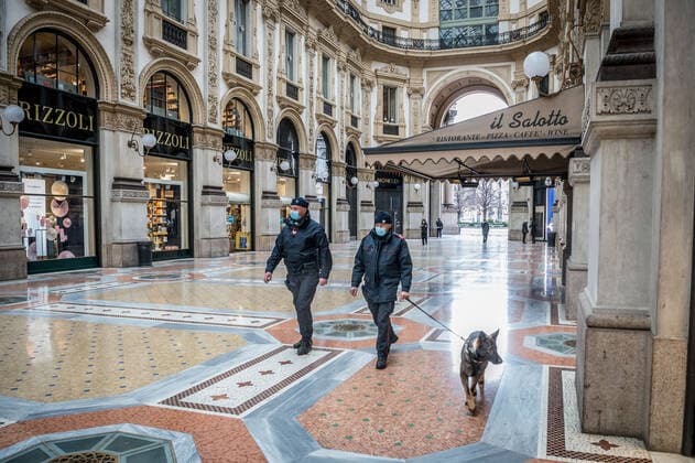 Milan. Dark Orange area few people in the street through the streets of the center In the photo dog carabinieri in the vittorio emanuele gallery Editorial Usage Only  Copyright: xCarloxCozzolix xIPAx