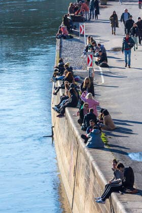 people sit in the sun at canal Donaukanal Wien, Vienna Wien Austria 02. Leopoldstadt