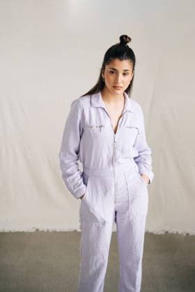 IMAGO Creative: Clickbait, Modetrends Unemotional young thoughtful female in stylish overall looking at camera standing in studio background Copyright: xJakexJakabx Model Released