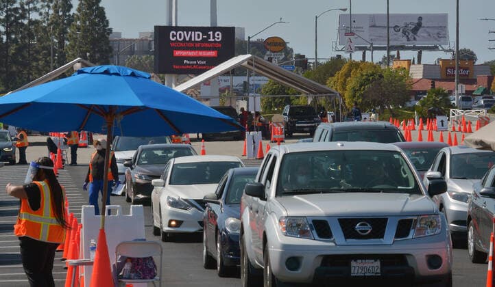 Drivers remain in their vehicles while being monitored to ensure they suffer no adverse reaction to the COVID-19 Moderna vaccine they received at the Forum in Inglewood, California on Saturday, March 6, 2021. As more Californians get vaccinated, the state will make it easier for counties to reopen, Newsom administration officials announced this week. Once 2 million coronavirus vaccines have been given to people in the state s most disadvantaged ZIP codes, the California Department of Public Health will lower the threshold for counties to move from the most restrictive purple tier into the less restrictive red tier.  LAP2021030615 JIMxRUYMEN