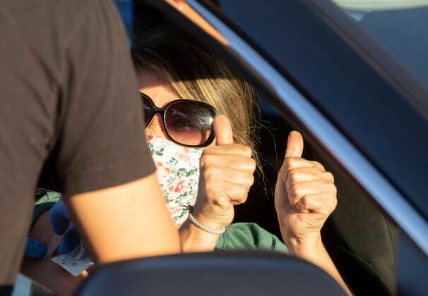 March 7, 2021, Round Rock, Texas, USA: Round Rock, TX USA March 6, 2021: A vaccinated woman gives a double thumbs up as Williamson County hosts a 24-hour vaccine marathon to catch up with COVID-19 vaccination schedule after last month s devastating winter storm that crippled much of Texas. The goal was to vaccinate up to 7,000 Texans with first or second Moderna doses. Round Rock USA - ZUMAd150 20210307_znp_d150_012 Copyright: xBobxDaemmrichx