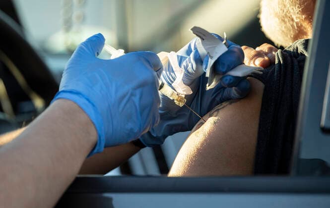 March 7, 2021, Round Rock, Texas, USA: Round Rock, TX USA March 6, 2021: Medical student Max Chehadi delivers vaccine to a patient at a Williamson County 24-hour vaccine marathon to catch up with COVID-19 vaccination schedule after last month s devastating winter storm that crippled much of Texas. The goal was to vaccinate up to 7,000 Texans with first or second Moderna doses. Round Rock USA - ZUMAd150 20210307_znp_d150_030 Copyright: xBobxDaemmrichx