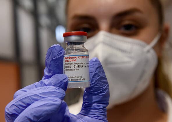An Israeli medic from Israel s Magen David Adam emergency agency holds a vial of the Moderna COVID-19 vaccine at the Lamed Hei Checkpoint between Gush Etzion and Beit Shemesh, on Monday, March 8, 2021. Israel started a two week campaign to vaccine some 100,000 Palestinian workers from the West Bank who hold permits to work in Israel and Jewish settlements. The vaccination campaign is a joint project by the Israeli Heath Ministry, Ministry of Defense, Land Crossing Authority and the Coordination of Government Activities in the Territories.  JER2021030818 DEBBIExHILL