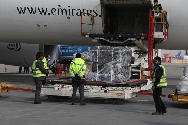 (210308) -- KABUL, March 8, 2021 -- Airport workers unload COVID-19 vaccines from COVAX, an international program devised to help low and middle-income countries to have more access to COVID-19 vaccines, at Hamid Karzai International Airport in Kabul, capital of Afghanistan, March 8, 2021. (Photo by Xinhua) AFGHANISTAN-KABUL-COVID-19 VACCINE-COVAX SayedxMominzadah 