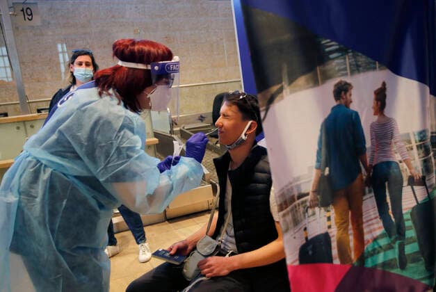 (210309) -- TEL AVIV, March 9, 2021 -- A traveler receives COVID-19 test upon his arrival at Ben Gurion International Airport near Tel Aviv, Israel, on March 8, 2021. Israel on Monday lifted the ban on entry of foreign nationals into the country, according to a statement issued by Israel s Population and Immigration Authority. (Photo by Xinhua) ISRAEL-AIRPORT-COVID-19-CONTROL MEASURES GilxCohenxMagen 
